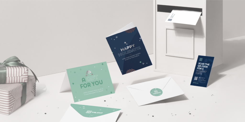 Colorful holiday cards and envelopes surround a gift box near a mailbox. A QR code offers a holiday gift.